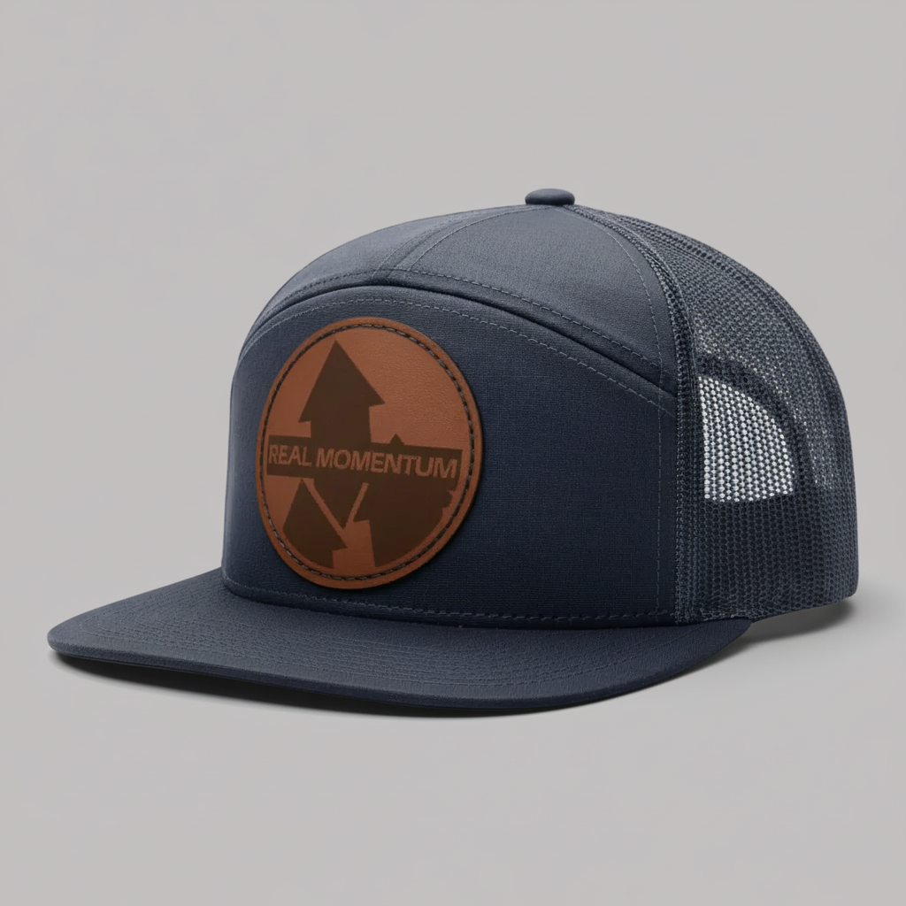 Navy blue cap with brown leather patch on a white background