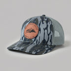 Camouflage-patterned cap with a pink patch on a light gray background