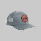 Gray cap with a red leather patch on a light gray background