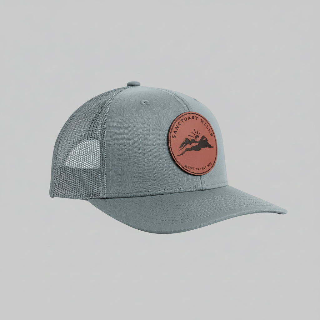 Gray cap with a red leather patch on a light gray background