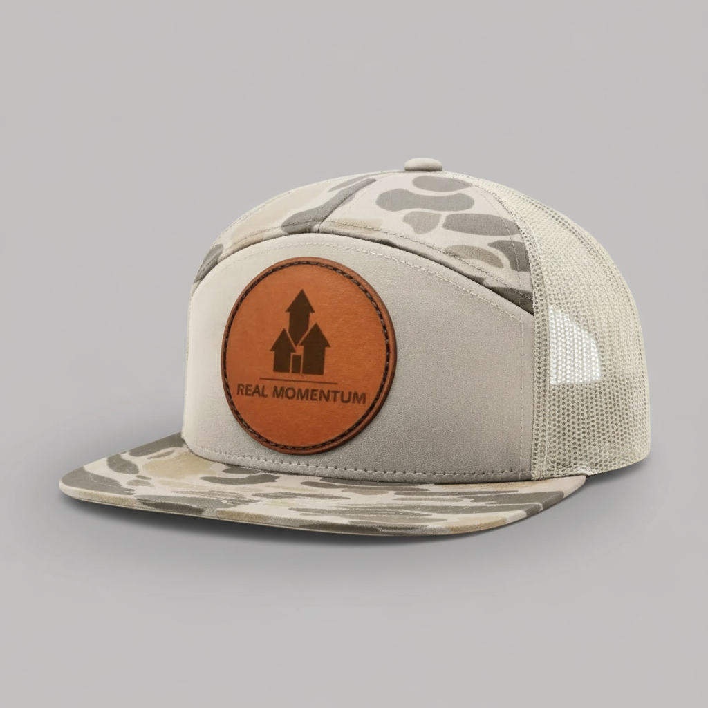 Beige and camouflage cap with a brown leather patch on a white background
